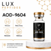 Bottle labeled AOD-9604 from Lux Peptides with icons for Fat Loss, Body Comp, Metabolic, Wellness on left; research disclaimer bottom left.