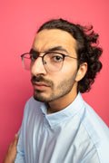close-up-view-strict-young-handsome-caucasian-man-wearing-glasses-standing-profile-view-isolated-crimson-wall